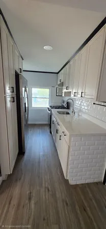 a room with wooden floors and window