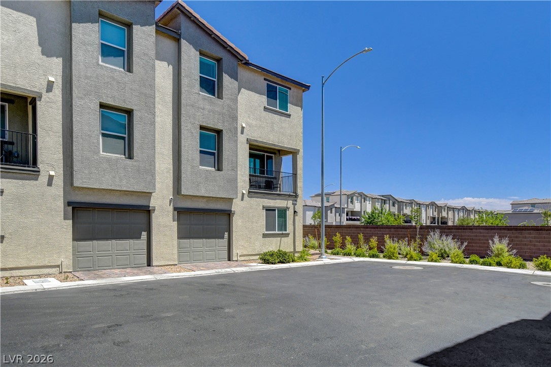 6924 Spicy Merlot Street North Las Vegas, NV 89086 - Photo 3 of 83 Multi-level modern construction with private garages offers urban living with ample parking.