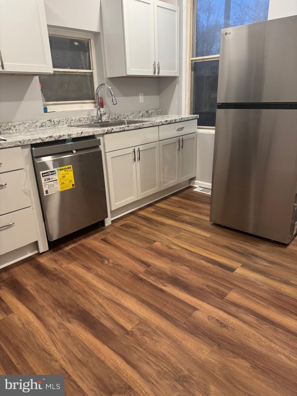 2732 Riggs Avenue Baltimore, MD 21216 - Photo 11 of 23 a kitchen with granite countertop a refrigerator sink and stove