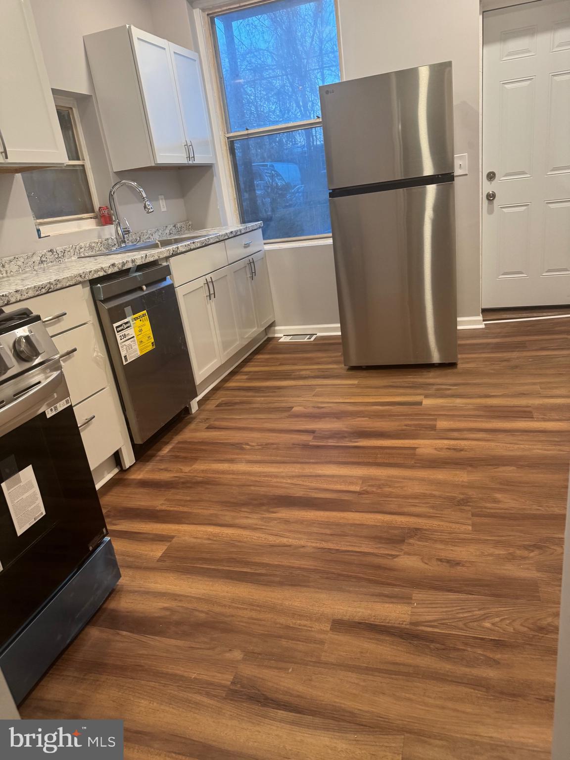 2732 Riggs Avenue Baltimore, MD 21216 - Photo 12 of 23 a kitchen with a refrigerator and a stove