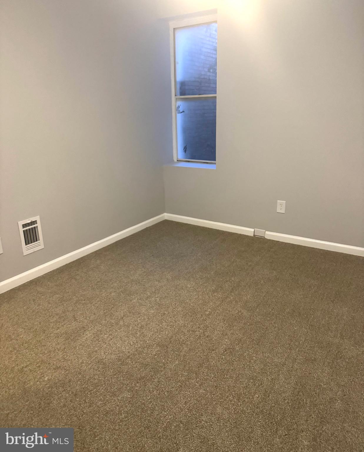 2732 Riggs Avenue Baltimore, MD 21216 - Photo 14 of 23 a view of an empty room with a window