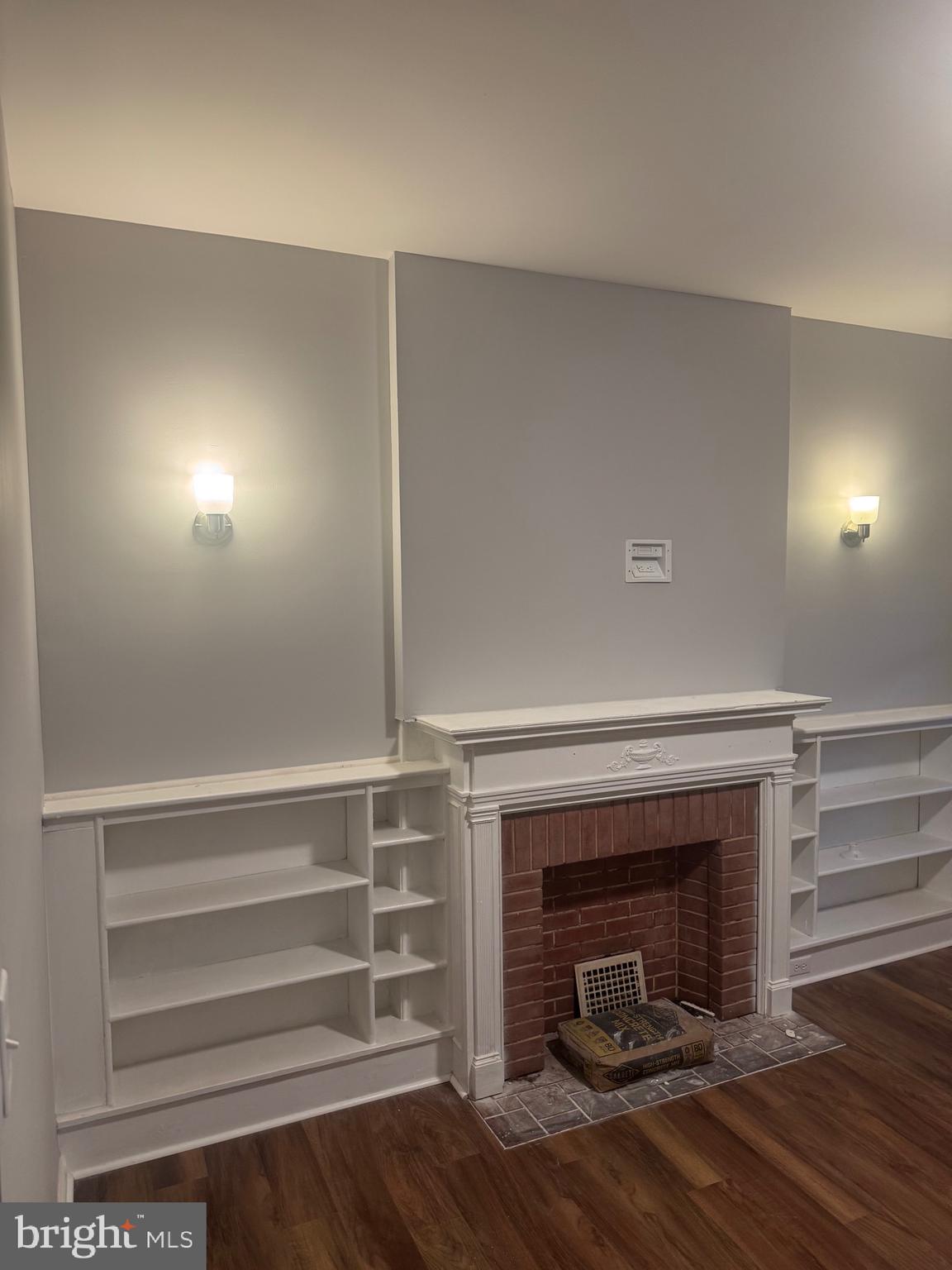 2732 Riggs Avenue Baltimore, MD 21216 - Photo 6 of 23 a view of a livingroom with wooden floor and a fireplace