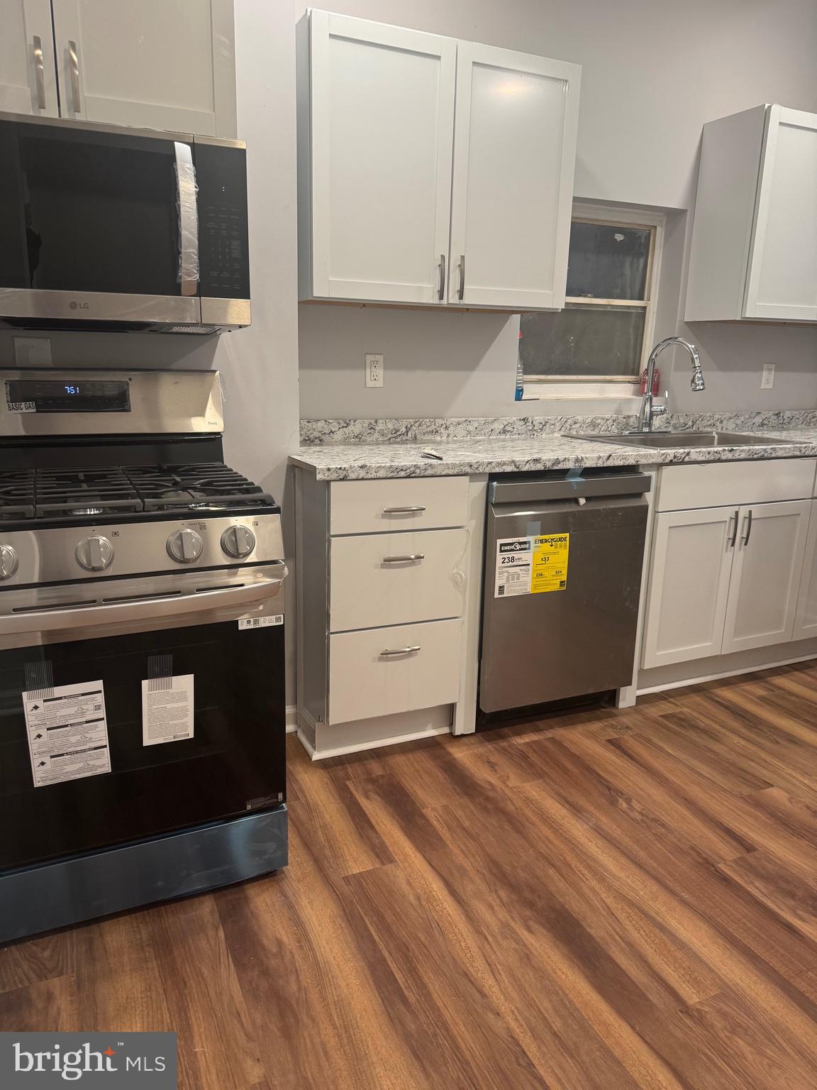2732 Riggs Avenue Baltimore, MD 21216 - Photo 8 of 23 a kitchen with granite countertop a stove and a sink