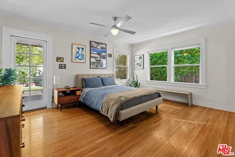 a bedroom with a large bed and a large window