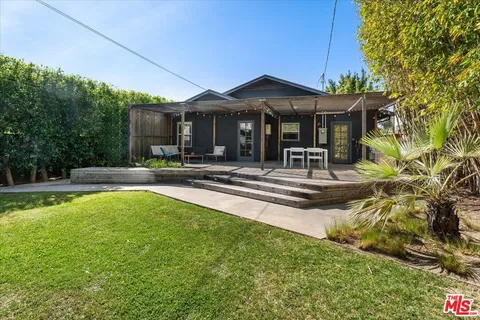 a swimming pool view with a seating space