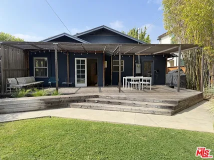 a view of a house with swimming pool and sitting area