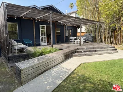 a view of a patio with table and chairs under an umbrella