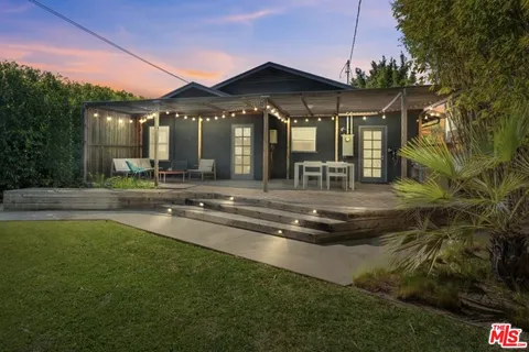 a swimming pool with outdoor seating and yard