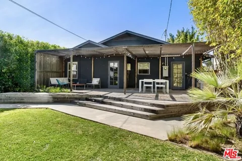 a view of a house with swimming pool and sitting area