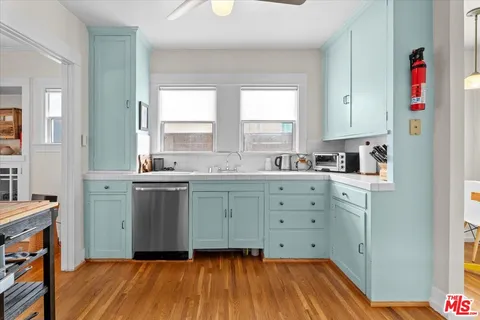 a kitchen with cabinets a sink and appliances