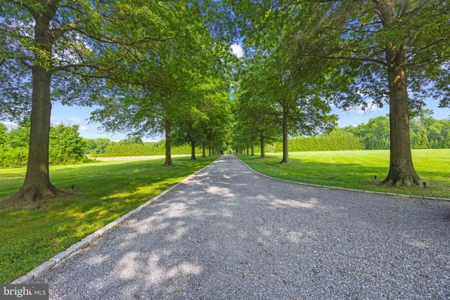 a view of a house with swimming pool and sitting area