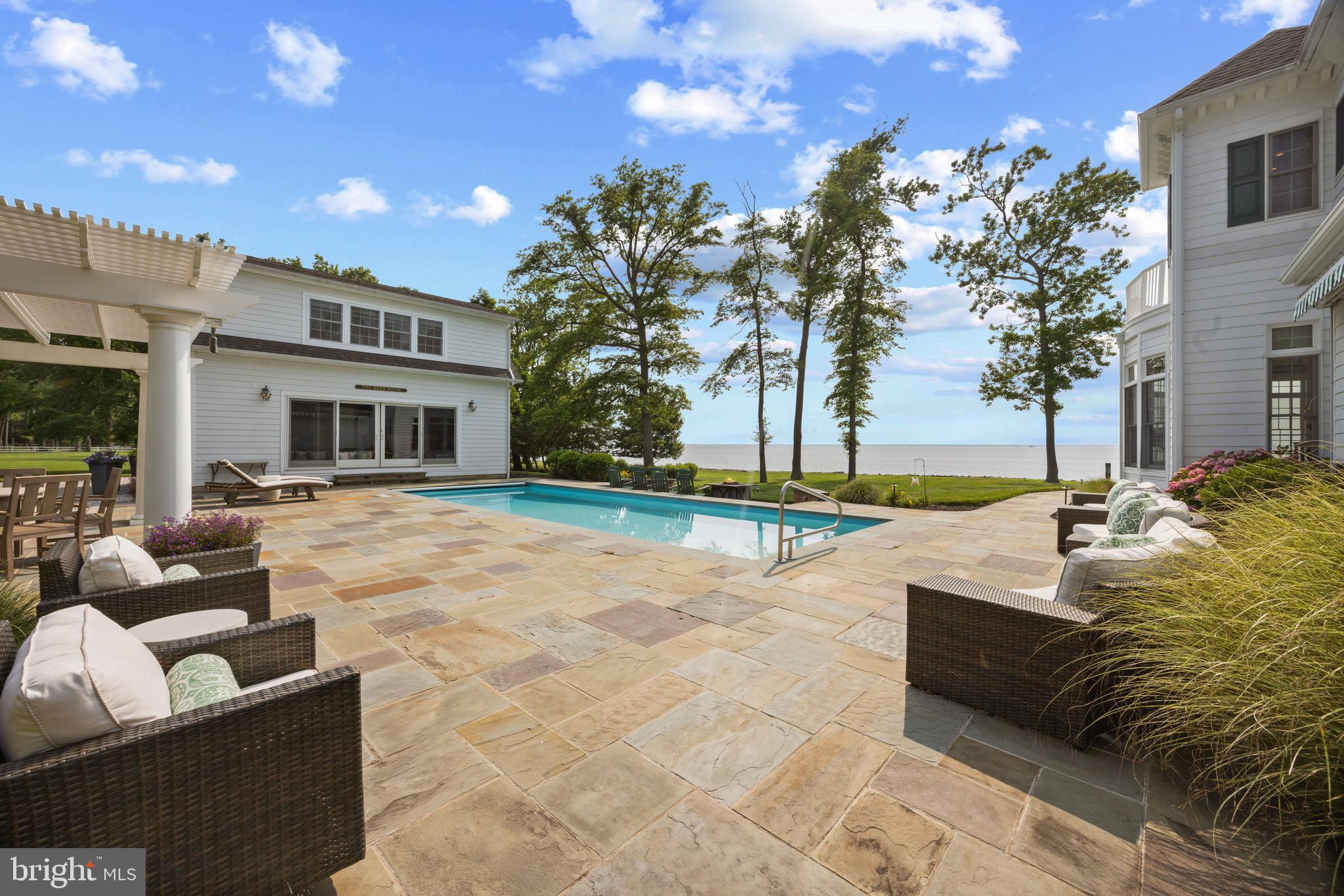 7680 Kent Point Road Stevensville, MD 21666 - Photo 10 of 22 a view of a house with swimming pool and sitting area