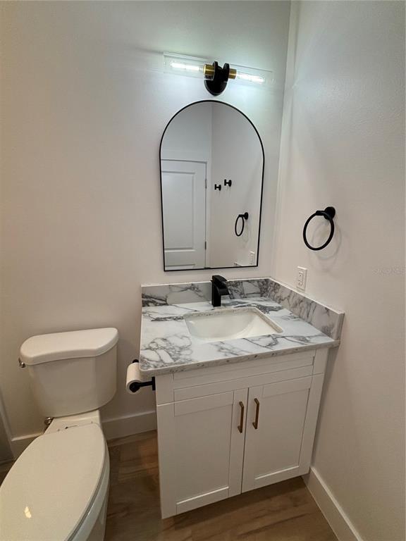 317 Quail Avenue Sebring, FL 33870 - Photo 11 of 19 a bathroom with a granite countertop toilet sink and mirror