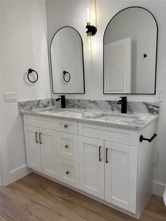 317 Quail Avenue Sebring, FL 33870 - Photo 16 of 19 a bathroom with a double vanity sink and a mirror