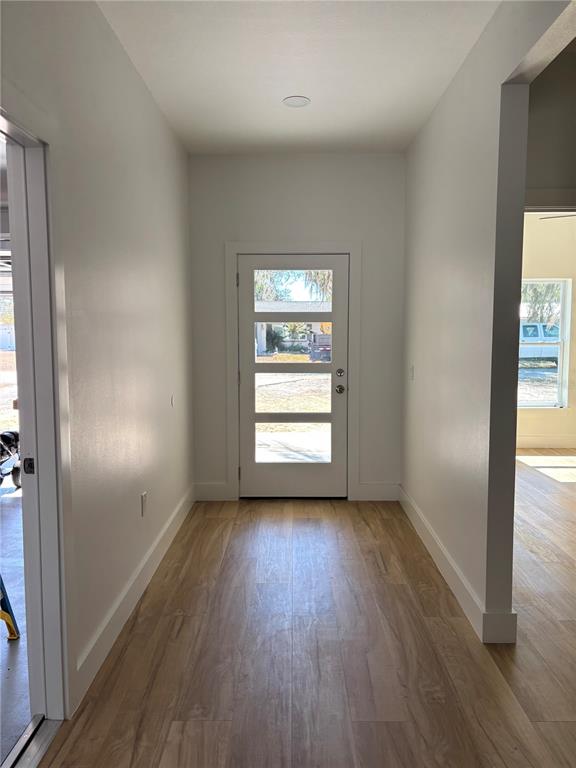 317 Quail Avenue Sebring, FL 33870 - Photo 3 of 19 a view of hallway with window and wooden floor