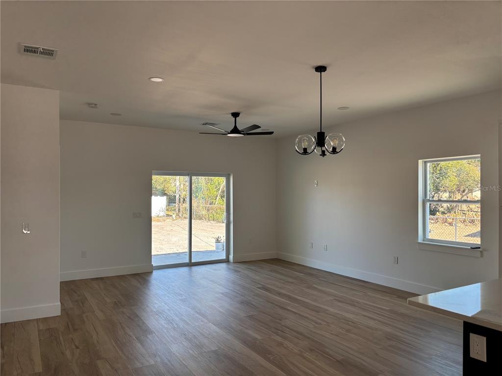 317 Quail Avenue Sebring, FL 33870 - Photo 7 of 19 a view of empty room with wooden floor and fan