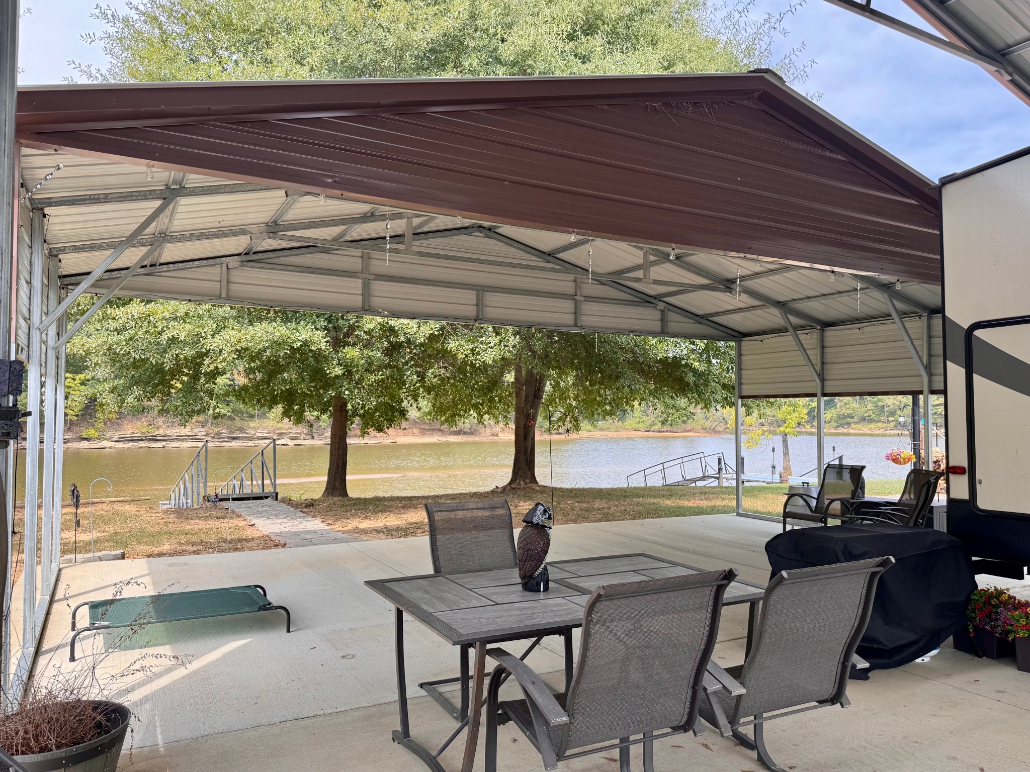 0 Ds Cove Decaturville, TN 38329 - Photo 42 of 60 a view of a patio with table and chairs under an umbrella with a small yard