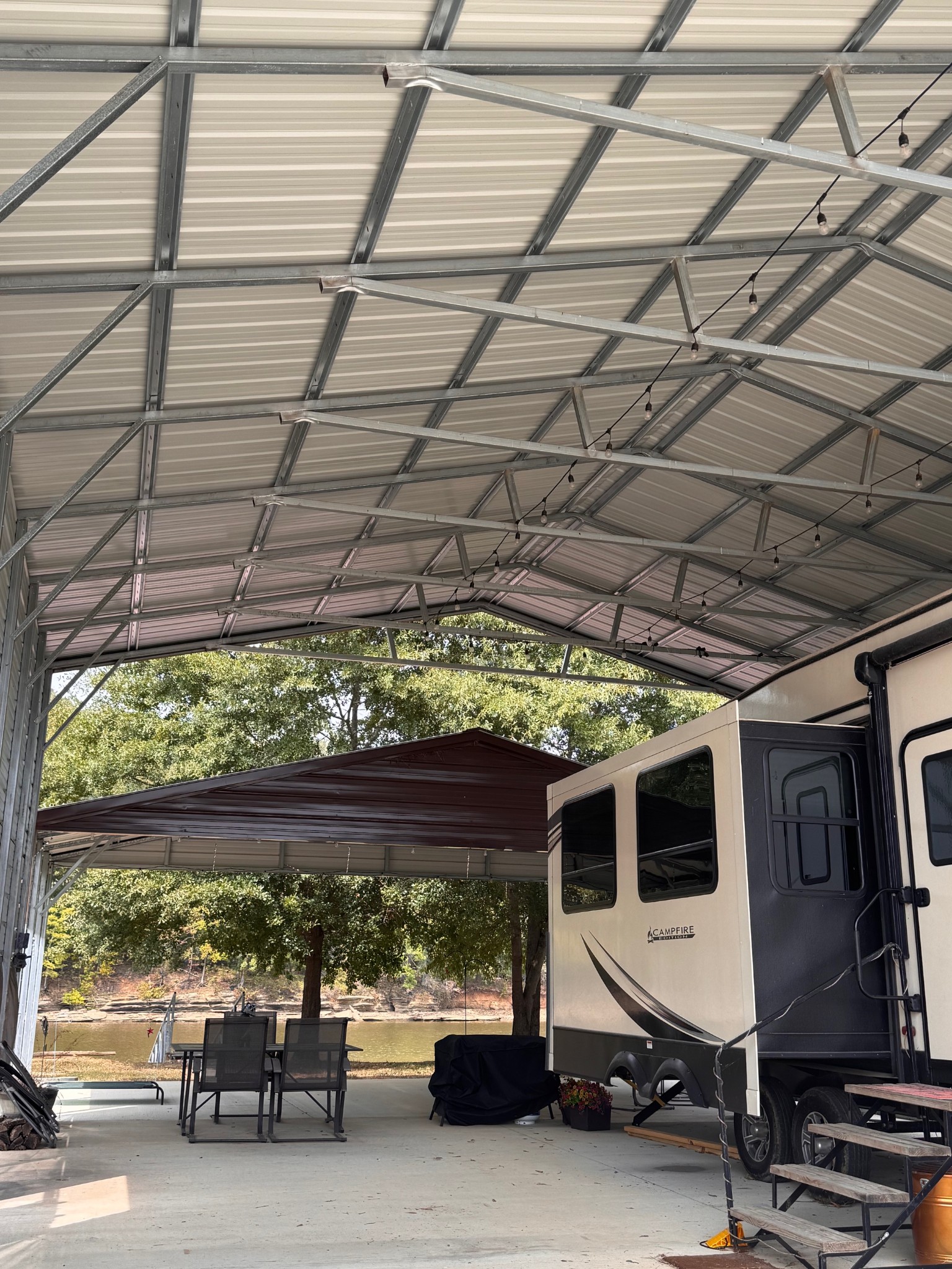 0 Ds Cove Decaturville, TN 38329 - Photo 46 of 60 a view of a patio with table and chairs under an umbrella with a small yard