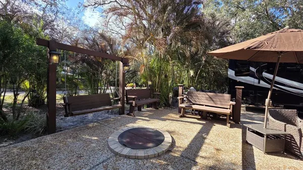 a view of a backyard with sitting area and furniture