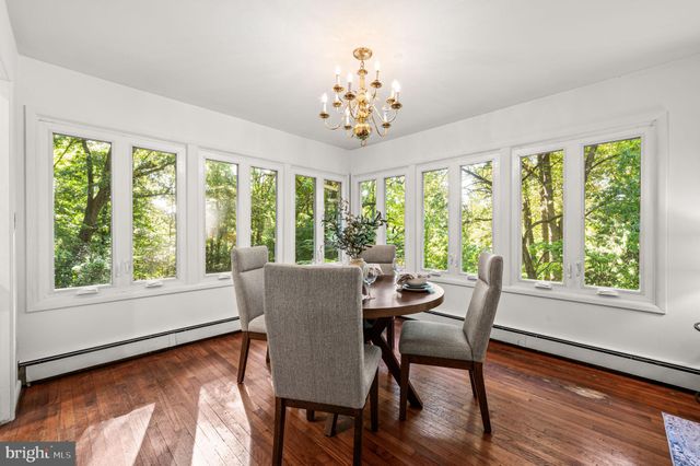 a living room with furniture dining table and a large window