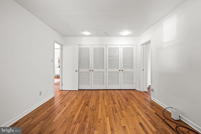 a view of room with window and wooden floor