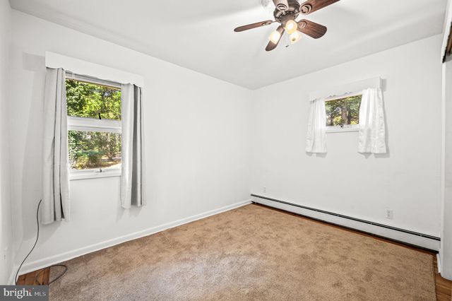 a spacious bedroom with a bed and a large window