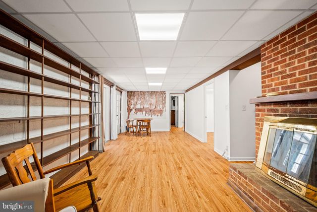 a view of a room with wooden floor and furniture