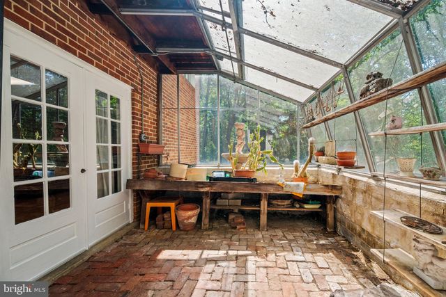 a view of empty room with wooden floor and staircase