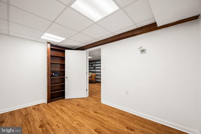 a view of a room with wooden floor