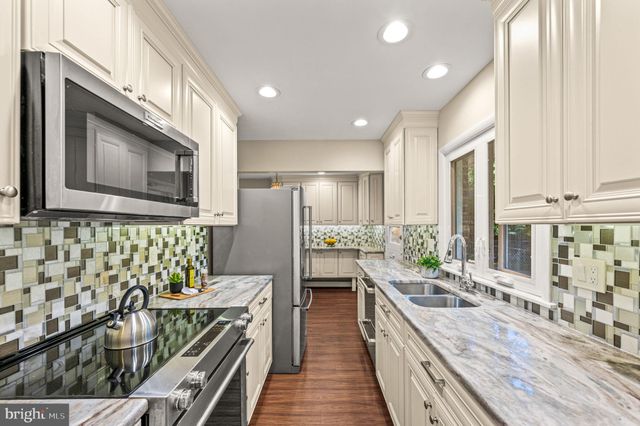 a view of a dining room with furniture wooden floor and chandelier