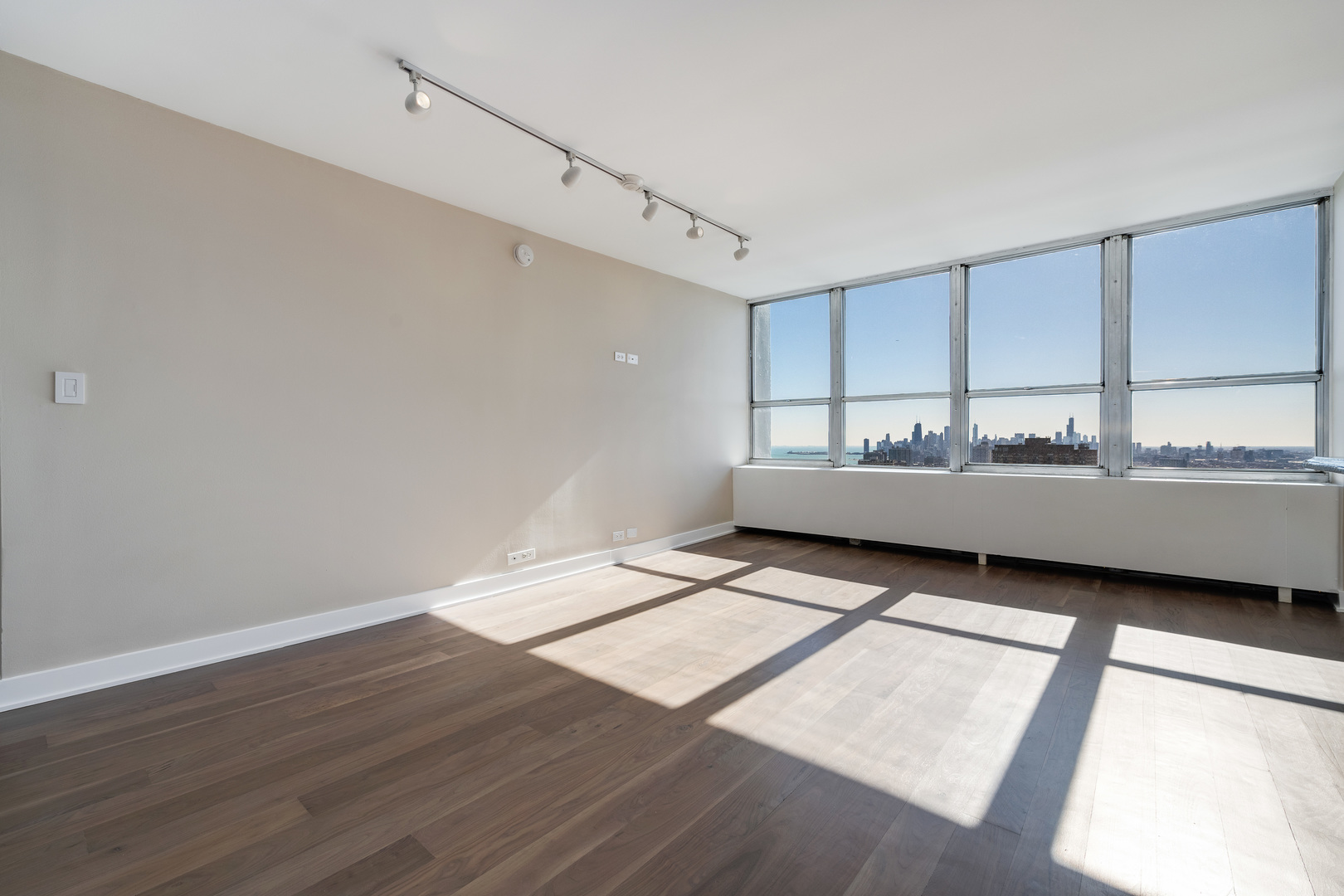 655 West Irving Park Road, Unit 5103 Chicago, IL 60613 - Photo 11 of 30 a view of wooden floor and windows in a room
