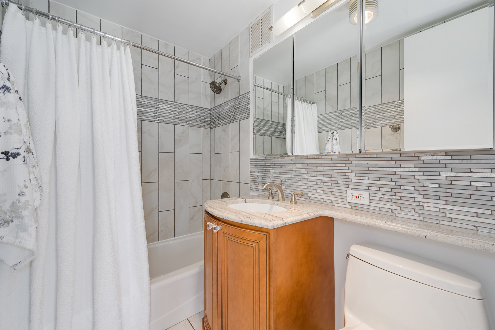 655 West Irving Park Road, Unit 5103 Chicago, IL 60613 - Photo 18 of 30 a bathroom with a sink and a mirror