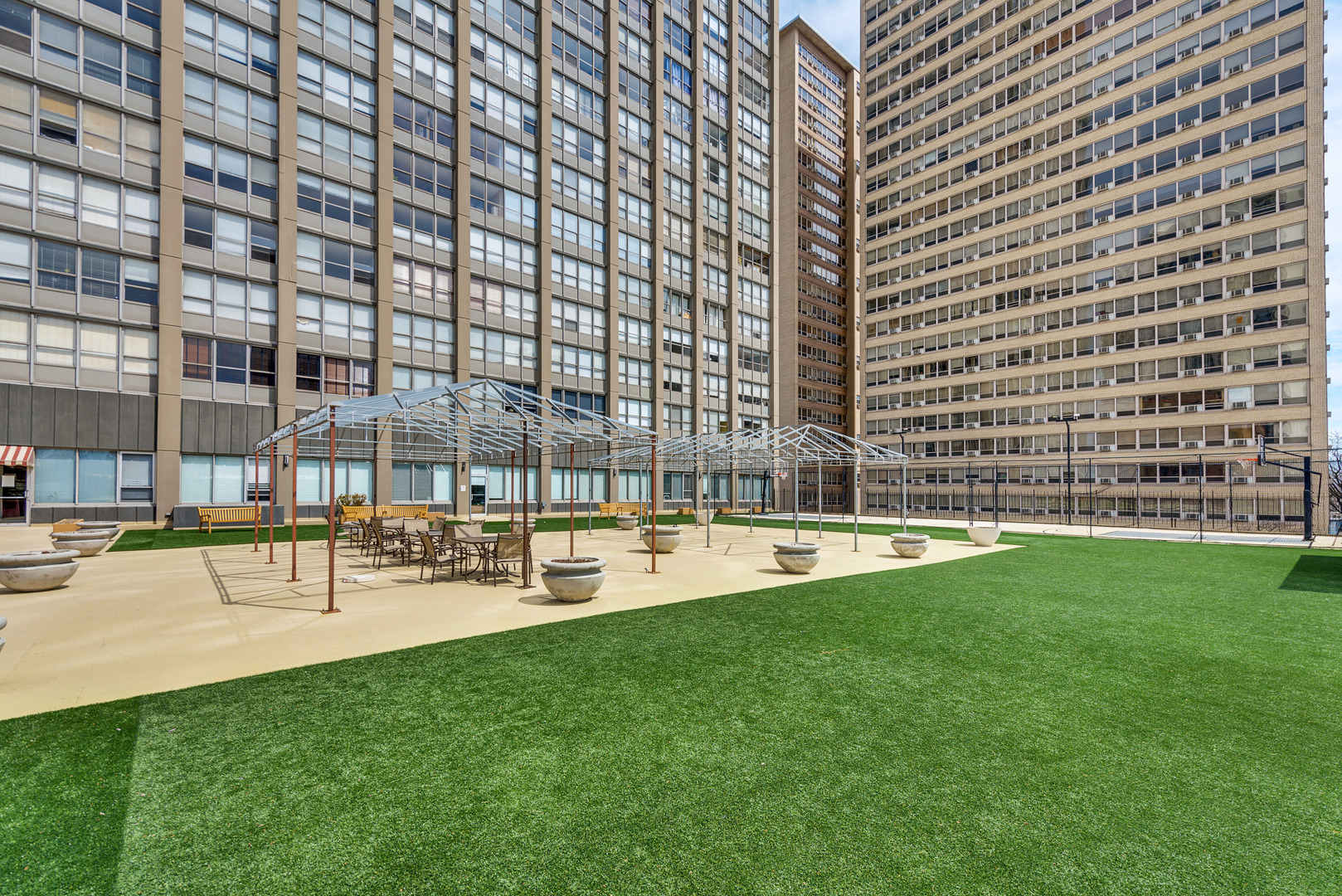 655 West Irving Park Road, Unit 5103 Chicago, IL 60613 - Photo 27 of 30 a view of swimming pool with outdoor seating and plants