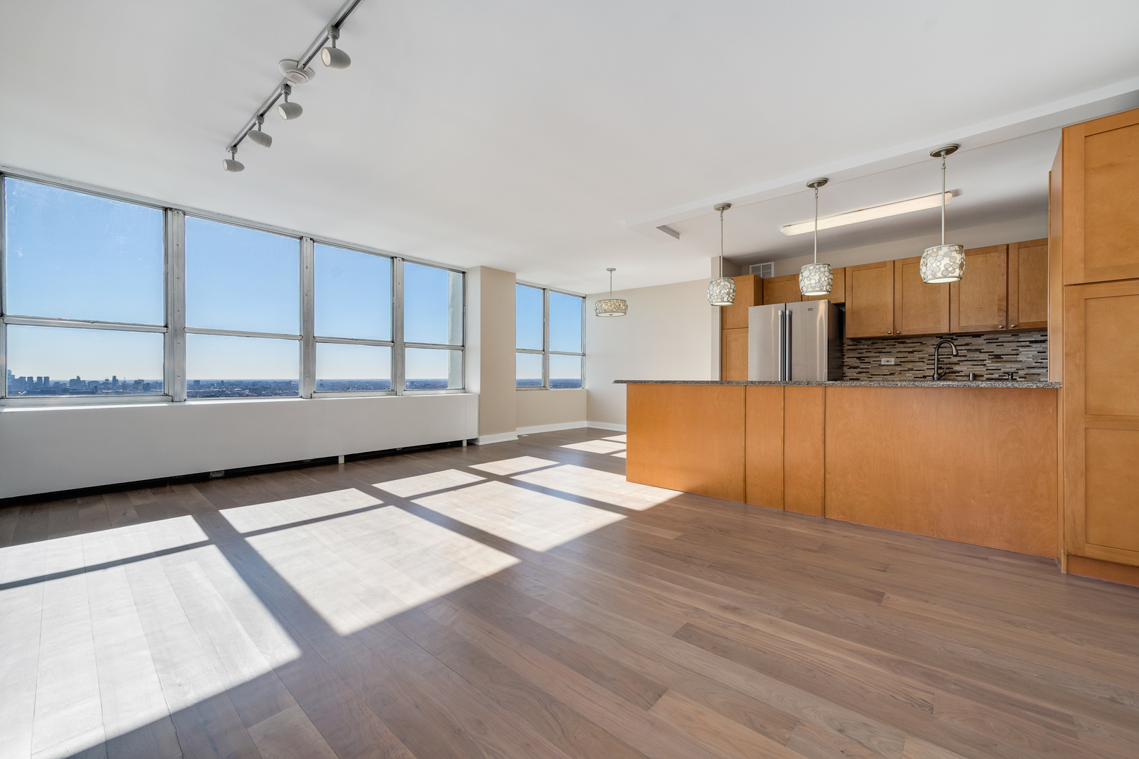 655 West Irving Park Road, Unit 5103 Chicago, IL 60613 - Photo 7 of 30 a view of a kitchen with furniture and wooden floor