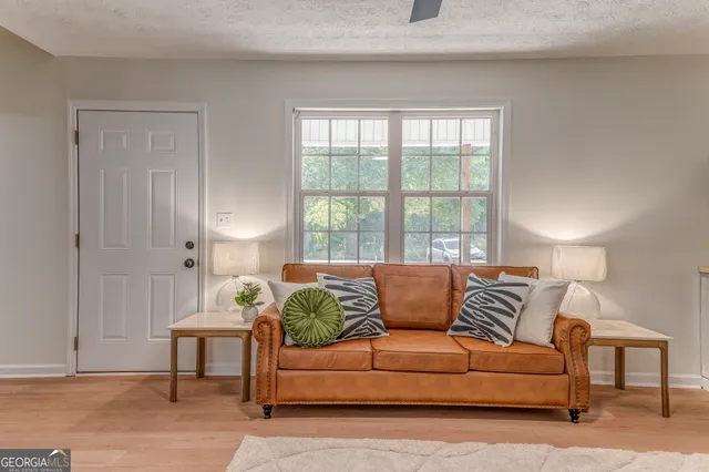 a living room with furniture and a large window