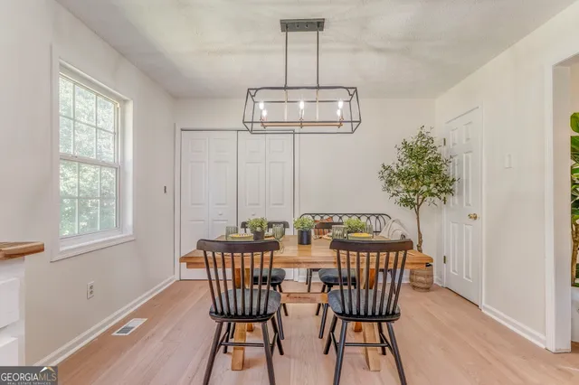 a view of a dining room with furniture window and wooden floor