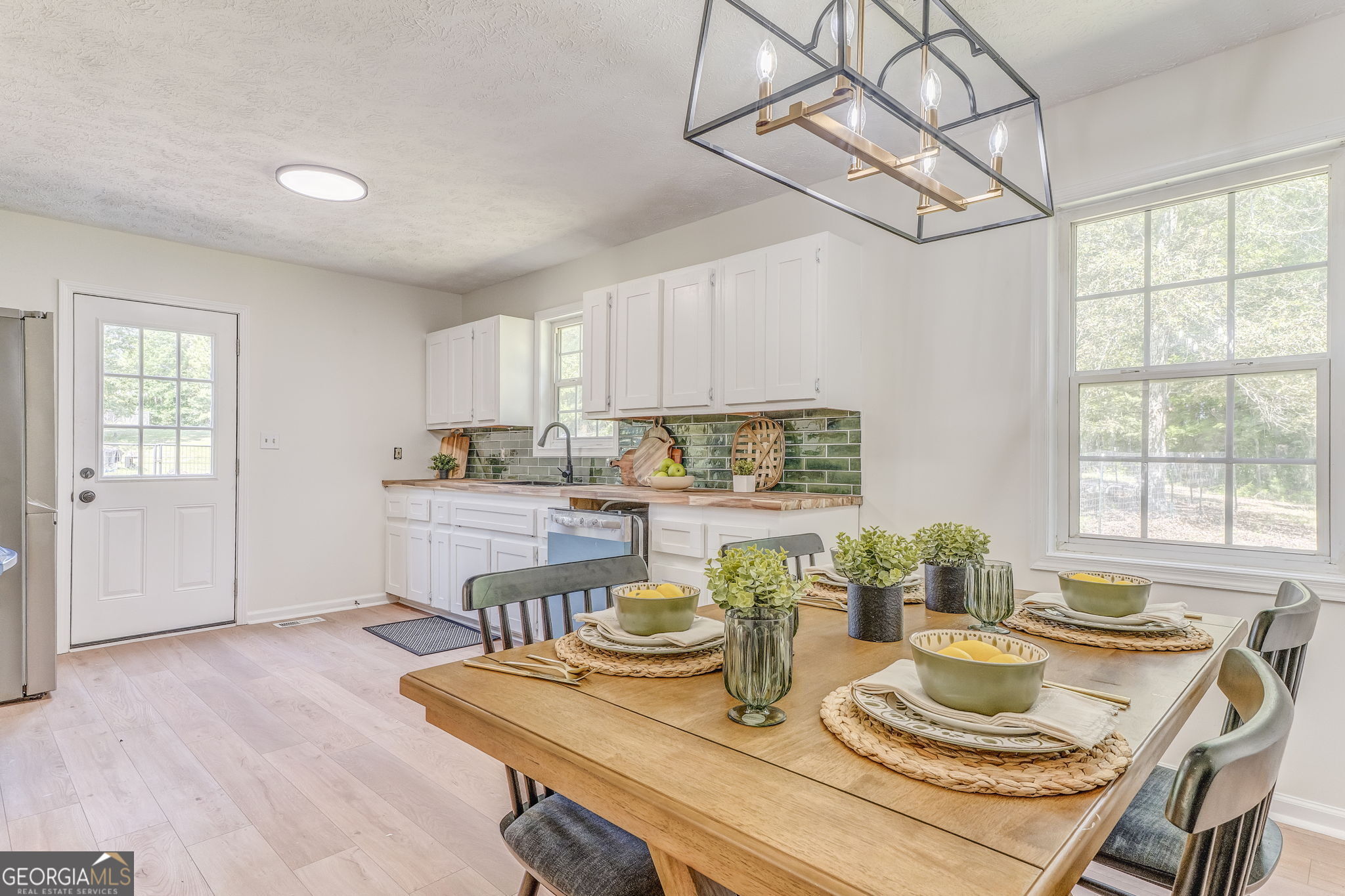 728 Hutto Road Cedartown, GA 30125 - Photo 15 of 40 a kitchen with a table chairs a stove and cabinets