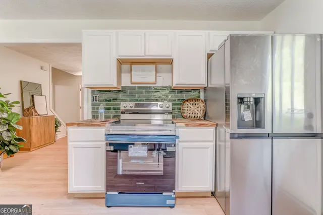a kitchen with kitchen island cabinets and appliances