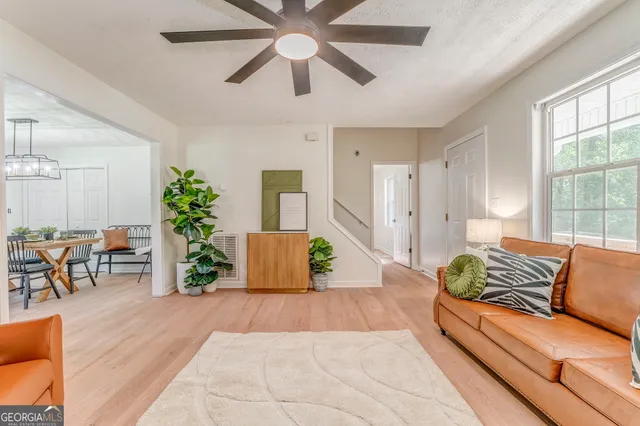 a living room with furniture and wooden floor