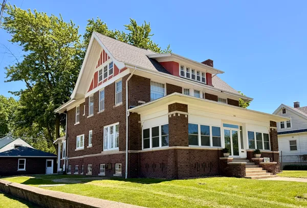 a front view of a building with garden