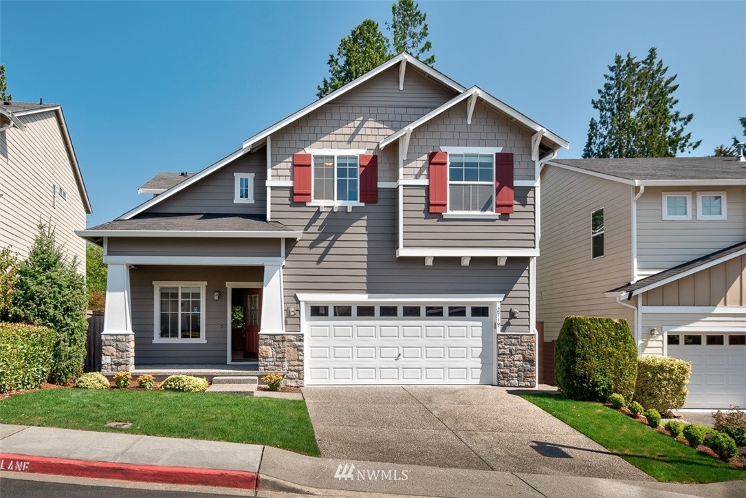2719 232nd Street Southeast Bothell, WA 98021 - Photo 1 of 24 a front view of a house with a yard and garage