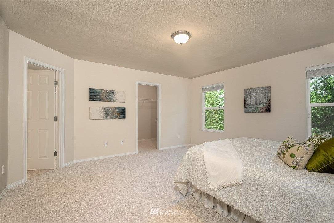 2719 232nd Street Southeast Bothell, WA 98021 - Photo 13 of 24 a bedroom with a bed and a painting