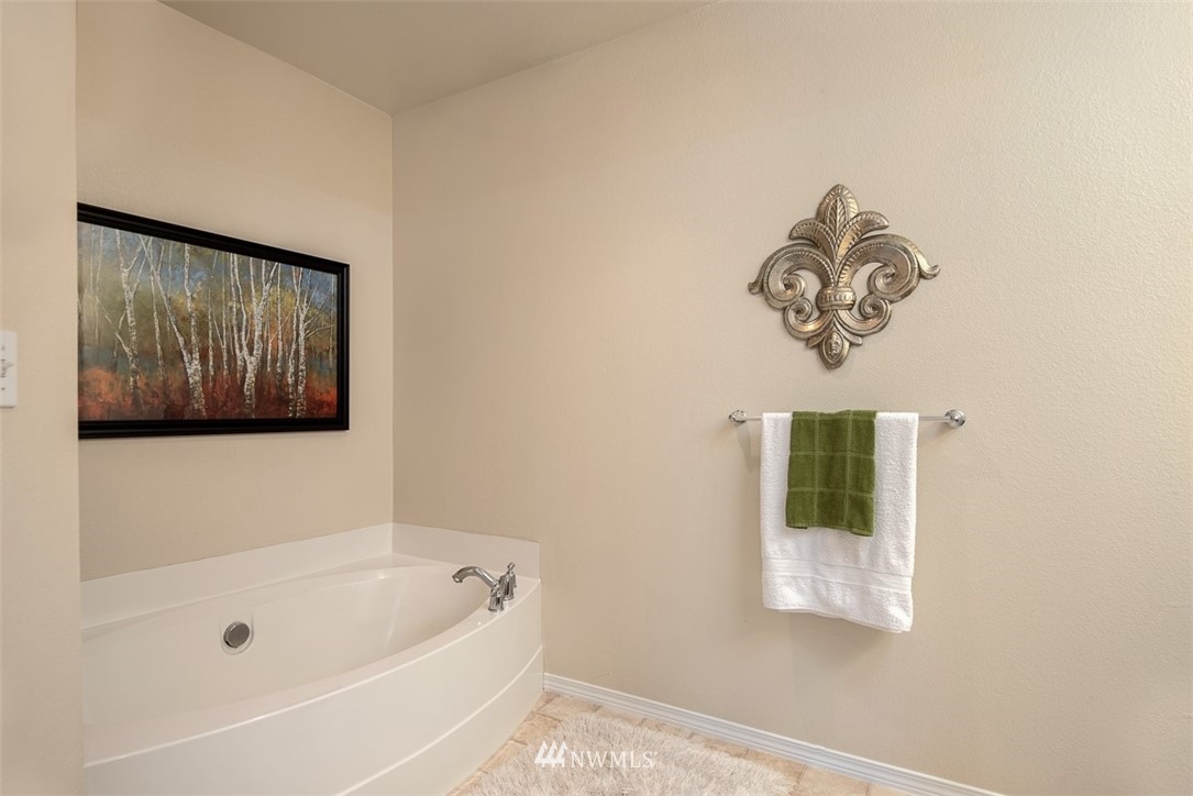 2719 232nd Street Southeast Bothell, WA 98021 - Photo 16 of 24 a bathroom with a bathtub and a window