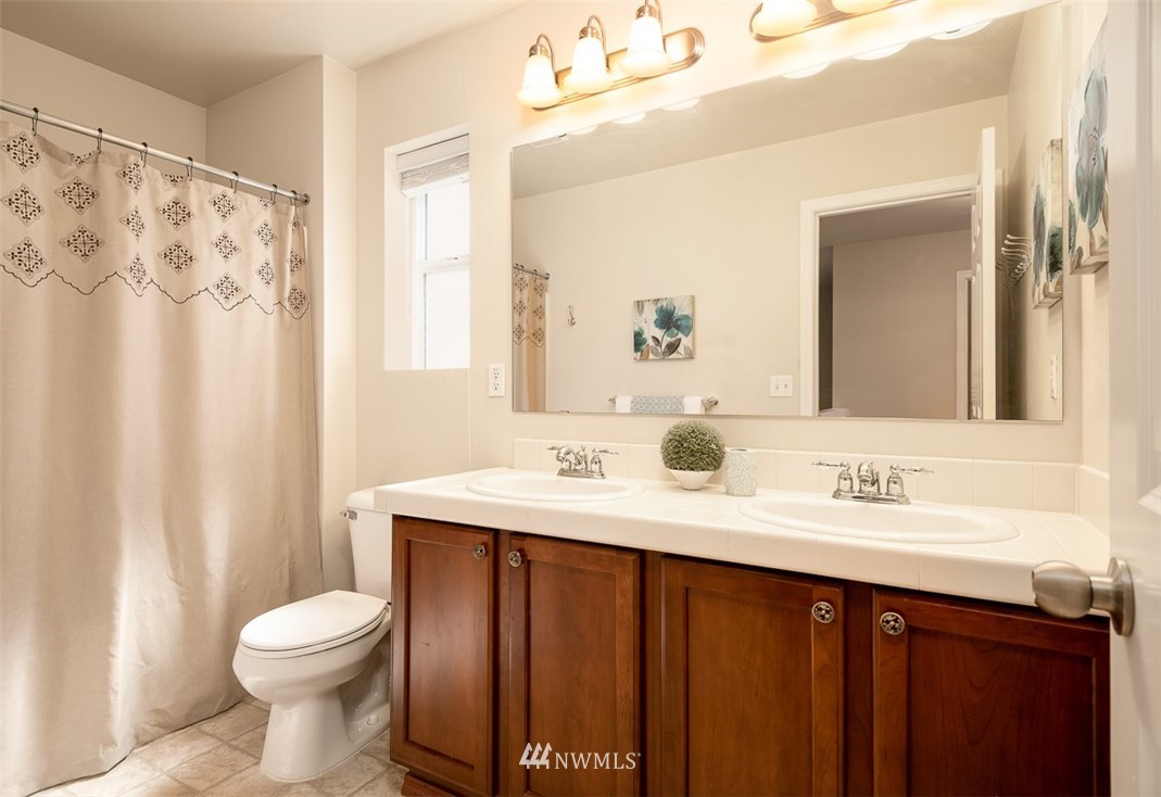 2719 232nd Street Southeast Bothell, WA 98021 - Photo 19 of 24 a bathroom with a sink vanity mirror and toilet