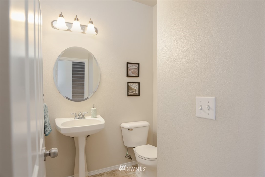2719 232nd Street Southeast Bothell, WA 98021 - Photo 5 of 24 a bathroom with a toilet sink and mirror