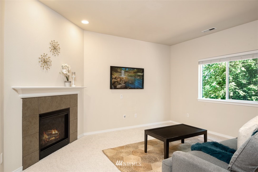 2719 232nd Street Southeast Bothell, WA 98021 - Photo 6 of 24 a living room with furniture and a fireplace
