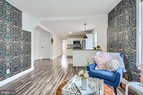 a living room with furniture and kitchen view