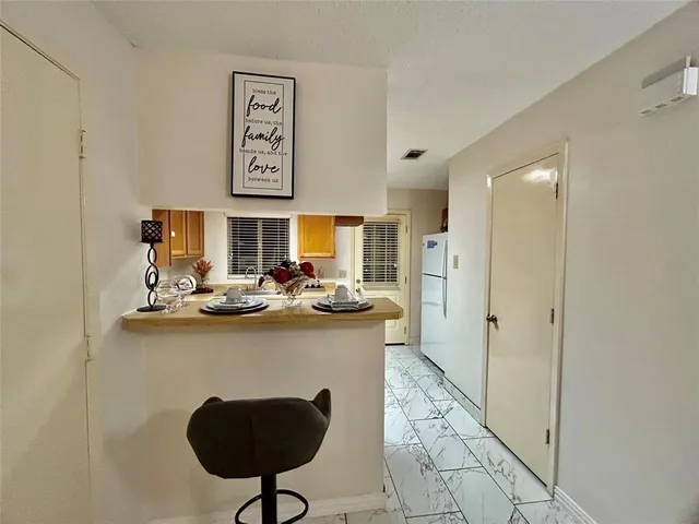 a kitchen with stainless steel appliances granite countertop a sink and a refrigerator