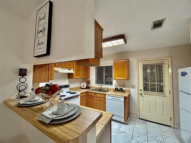 a kitchen with a sink stove and cabinets