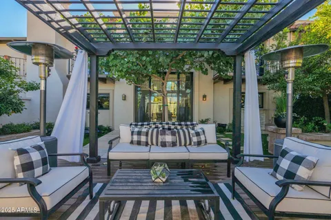 a view of a patio with couches table and chairs and potted plants